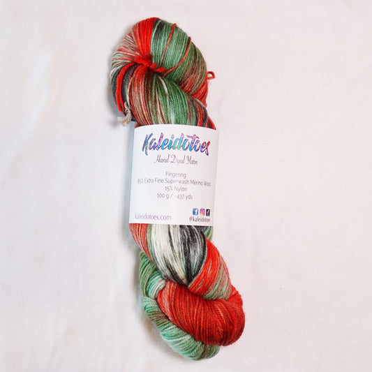 Hand-dyed fingering weight yarn with salmon orange, wasabi green, deep black-green nori, and white in a bold variegated colorway.