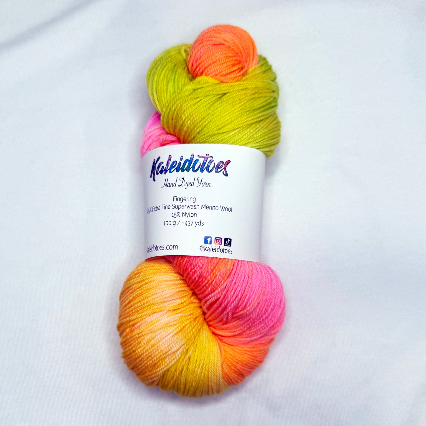 Hand-dyed yarn in mango, tangerine, pink, and lime tones — bright, juicy, and tropical like a summer fruit cocktail.