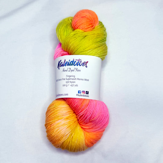 Hand-dyed yarn in mango, tangerine, pink, and lime tones — bright, juicy, and tropical like a summer fruit cocktail.