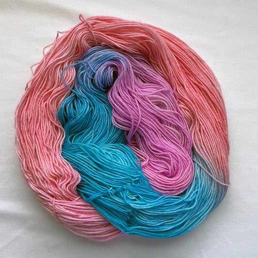 Indie dyed yarn skein, Sugarplum Princess, pastel pink and lilac with turquoise accents