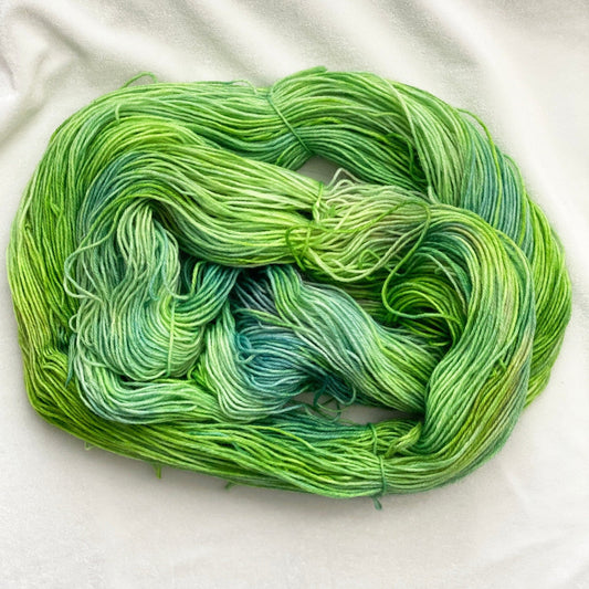Spring Meadow fingering weight yarn in shades of green, blue, and purple